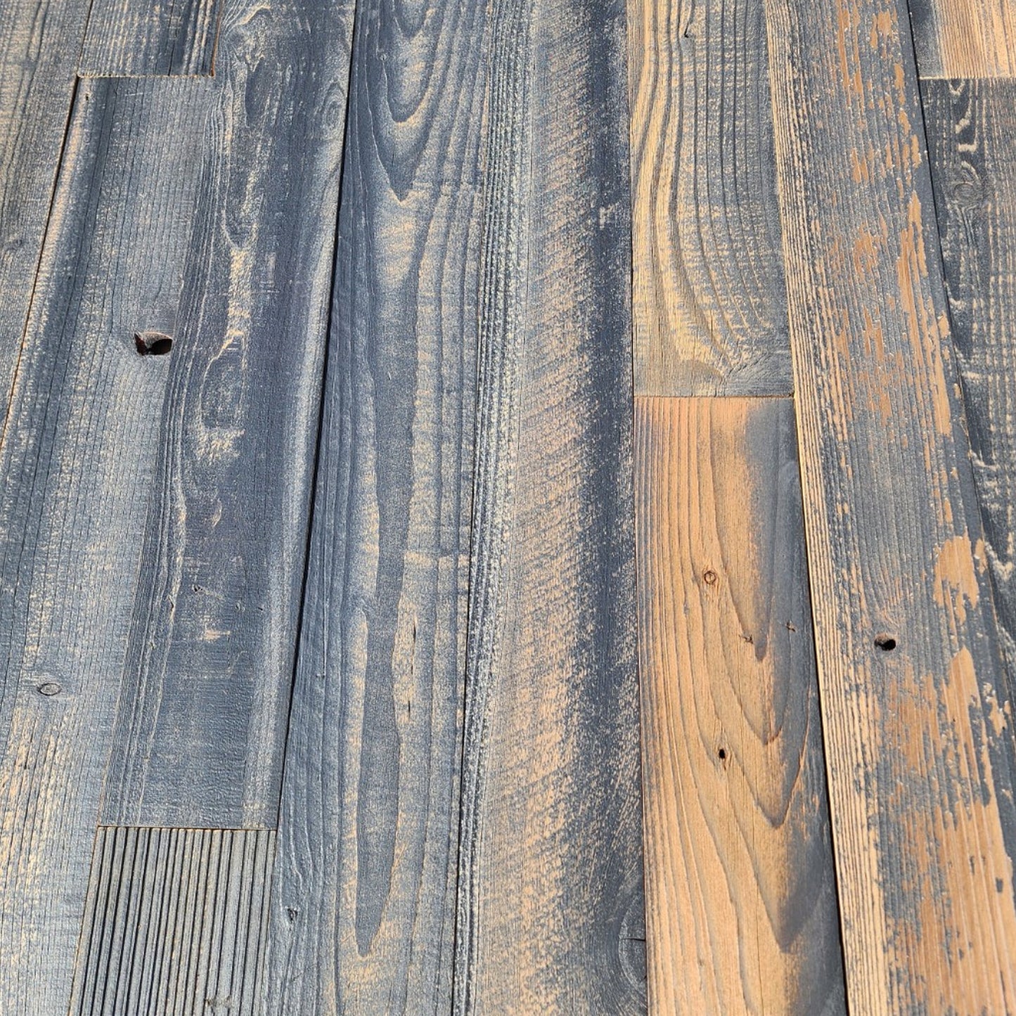 Black finish reclaimed redwood planks showing board to board color variation across a full layout