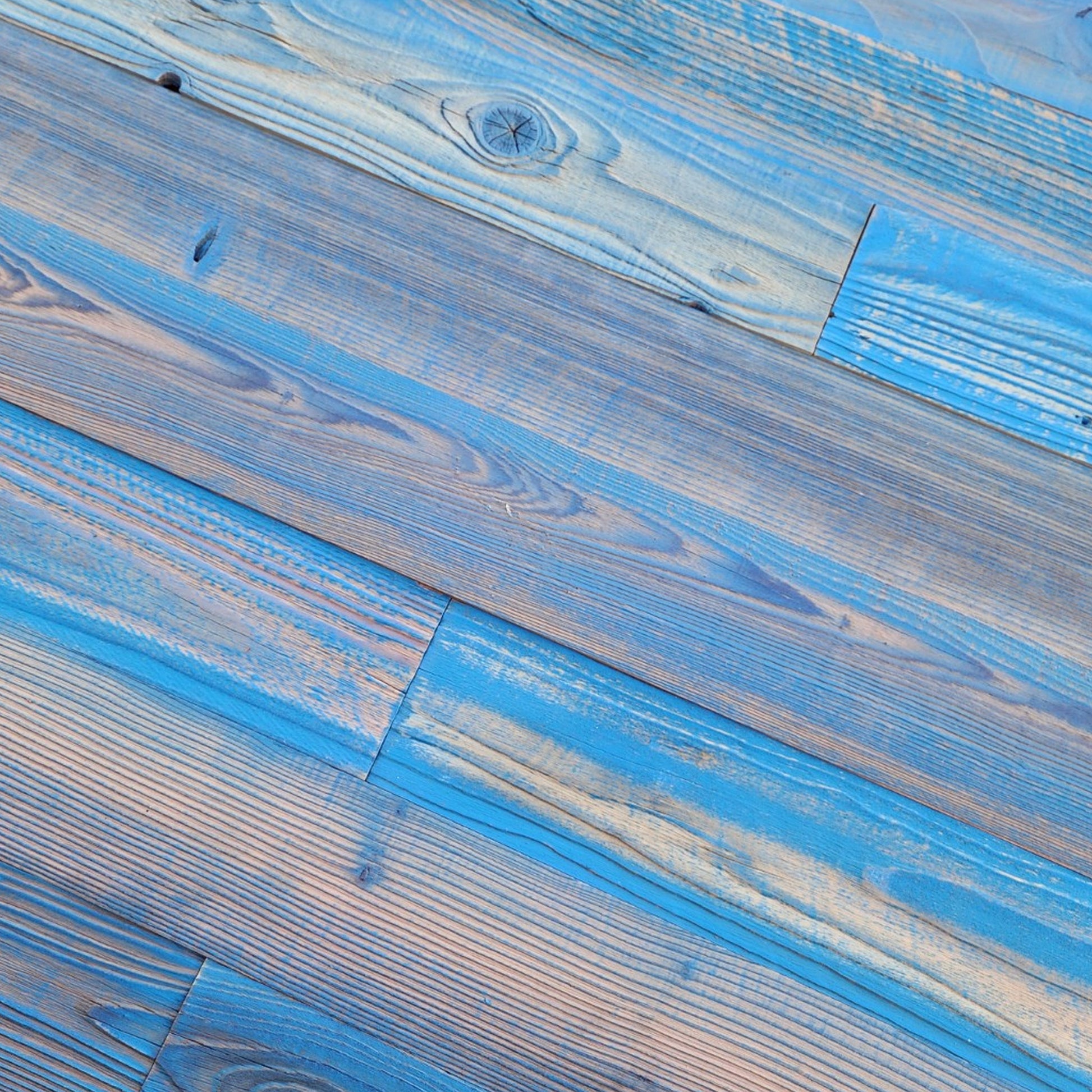 Close up of blue finish reclaimed redwood showing weathered texture and board to board variation