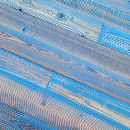 Close up of blue finish reclaimed redwood showing weathered texture and board to board variation