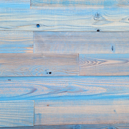 Blue finish reclaimed redwood S3S wall planks laid flat, bright denim blue over visible grain