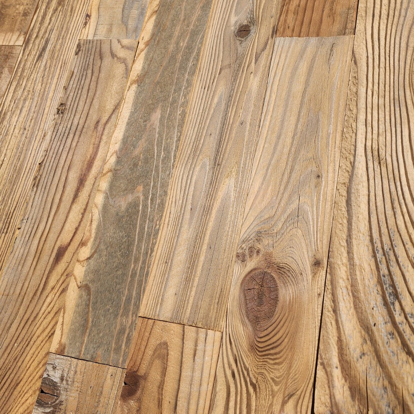 Close up of wire brushed reclaimed redwood showing raised grain, knots and saw marks