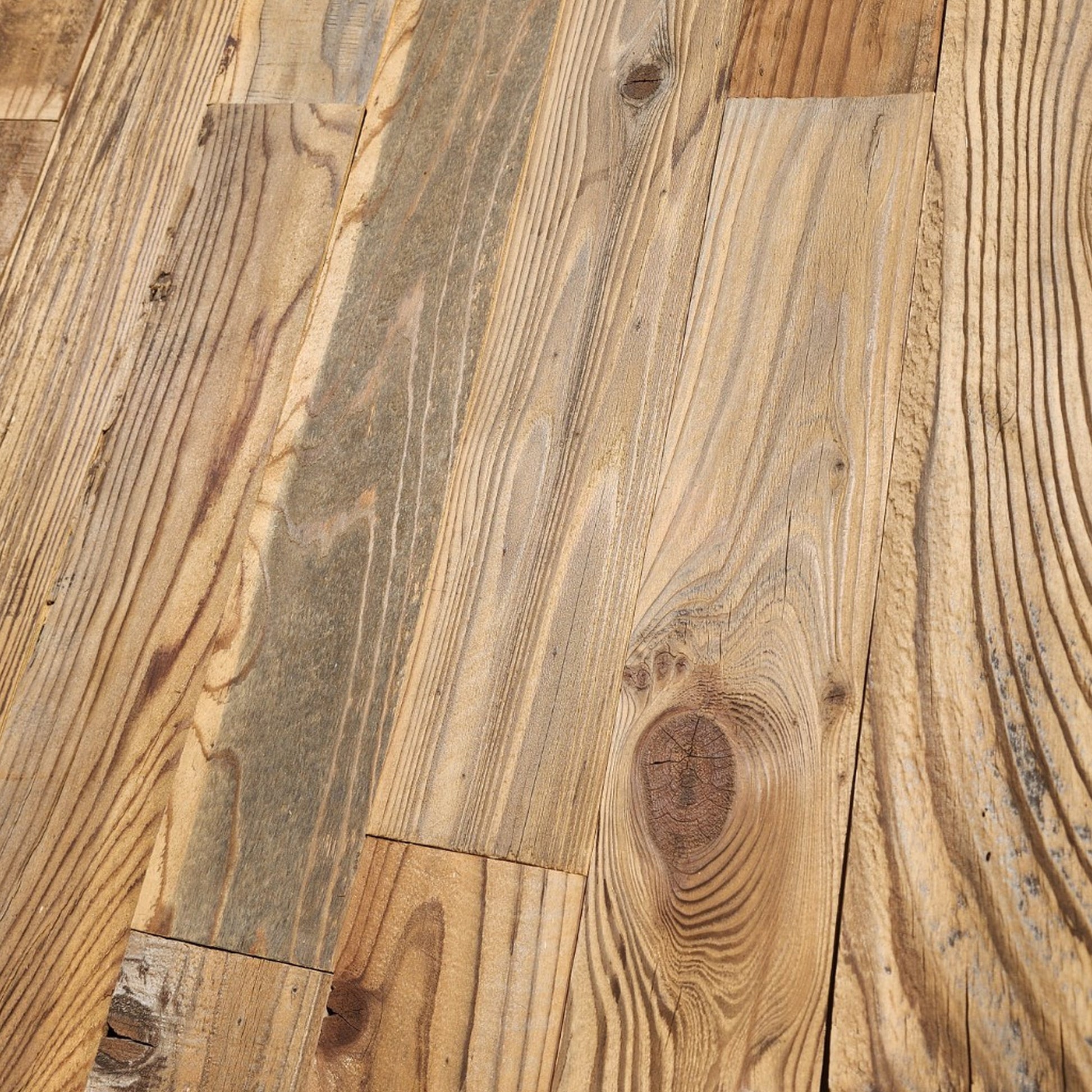 Close up of wire brushed reclaimed redwood showing raised grain, knots and saw marks