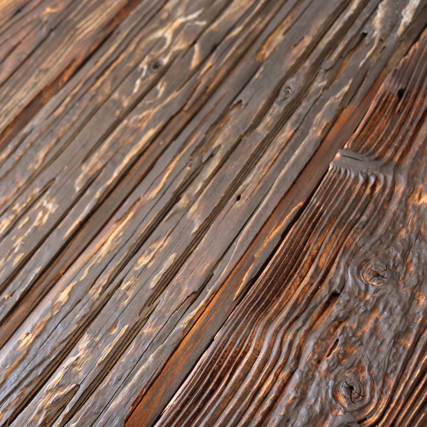 Reclaimed mushroom wood cladding showing deep grain relief and rustic edges