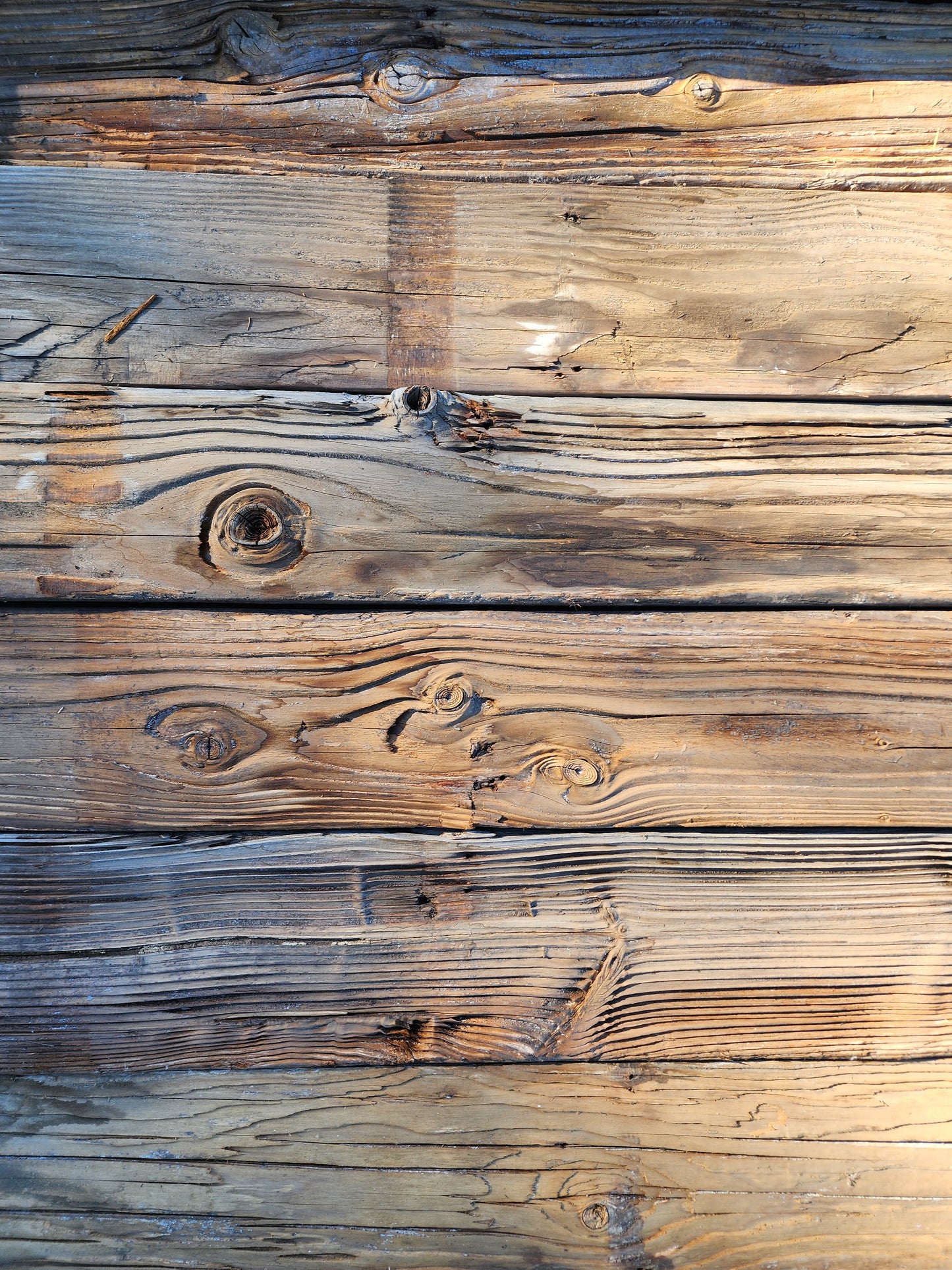Reclaimed mushroom wood siding plank with deeply weathered rustic character