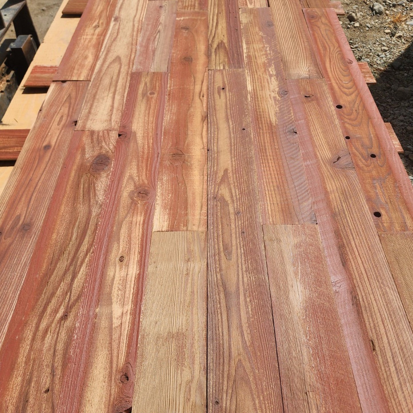 Red finish reclaimed redwood showing board to board color variation across a full layout