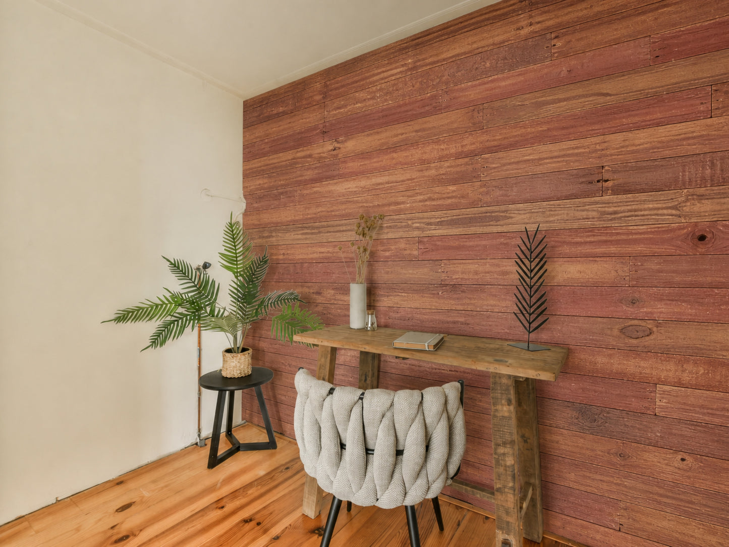 Red reclaimed redwood wall planks installed in an arched dining room niche