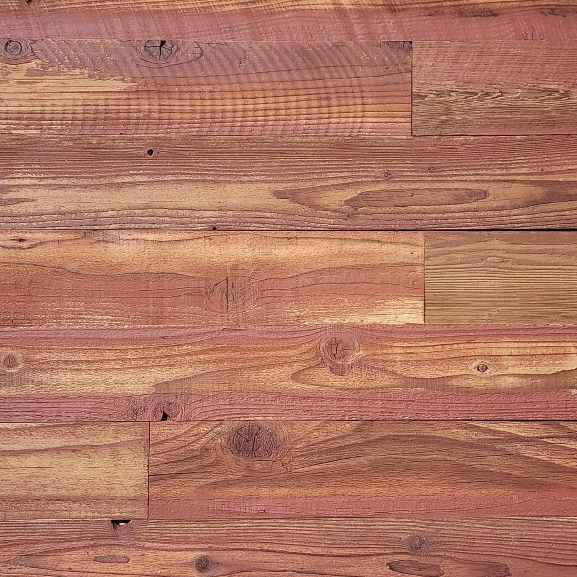 Red finish reclaimed redwood S3S wall planks laid flat, warm terracotta over visible grain
