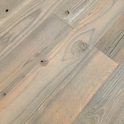 Close up of tan finish reclaimed redwood showing grain and original nail holes