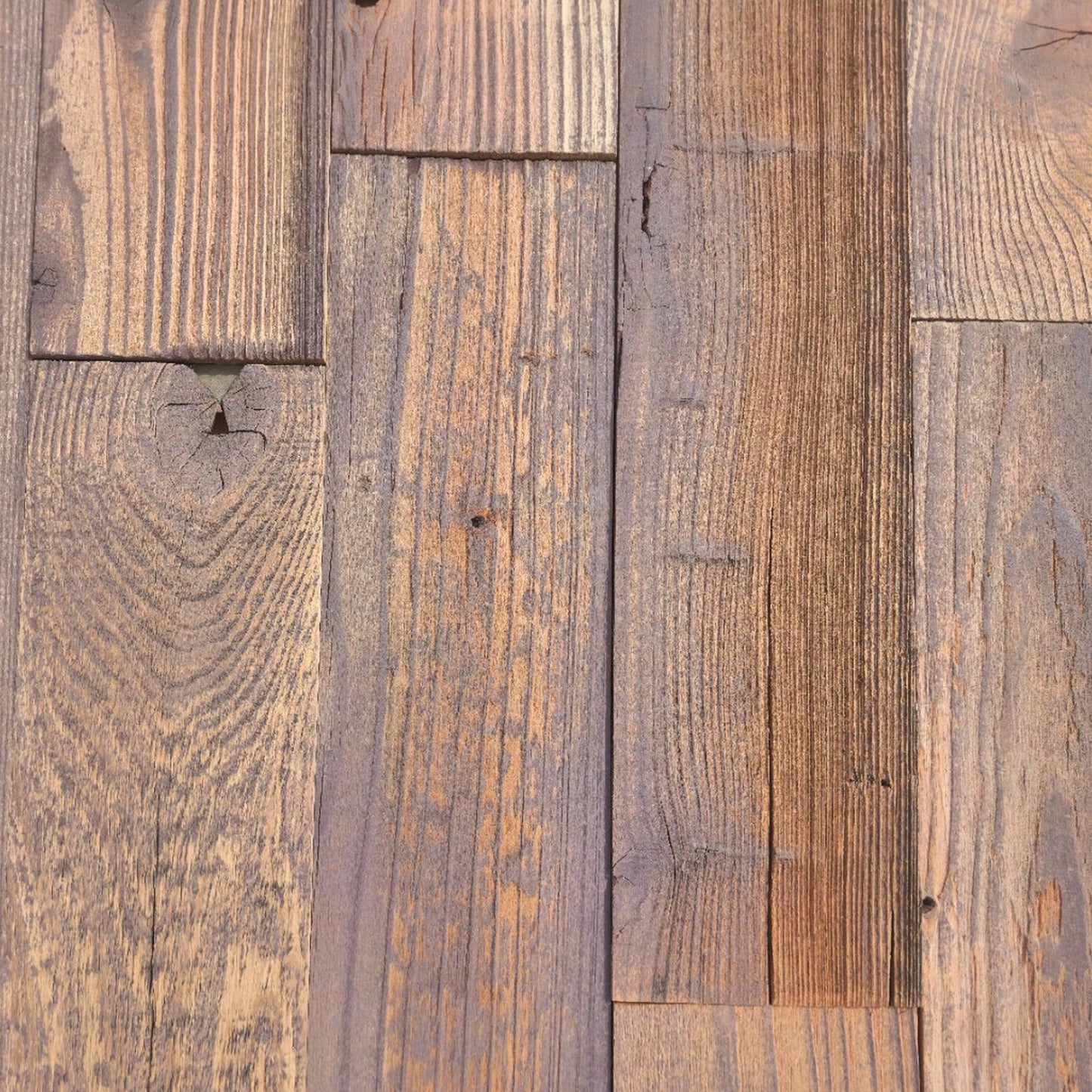 Close up of umber finish reclaimed redwood showing saw marks and checking