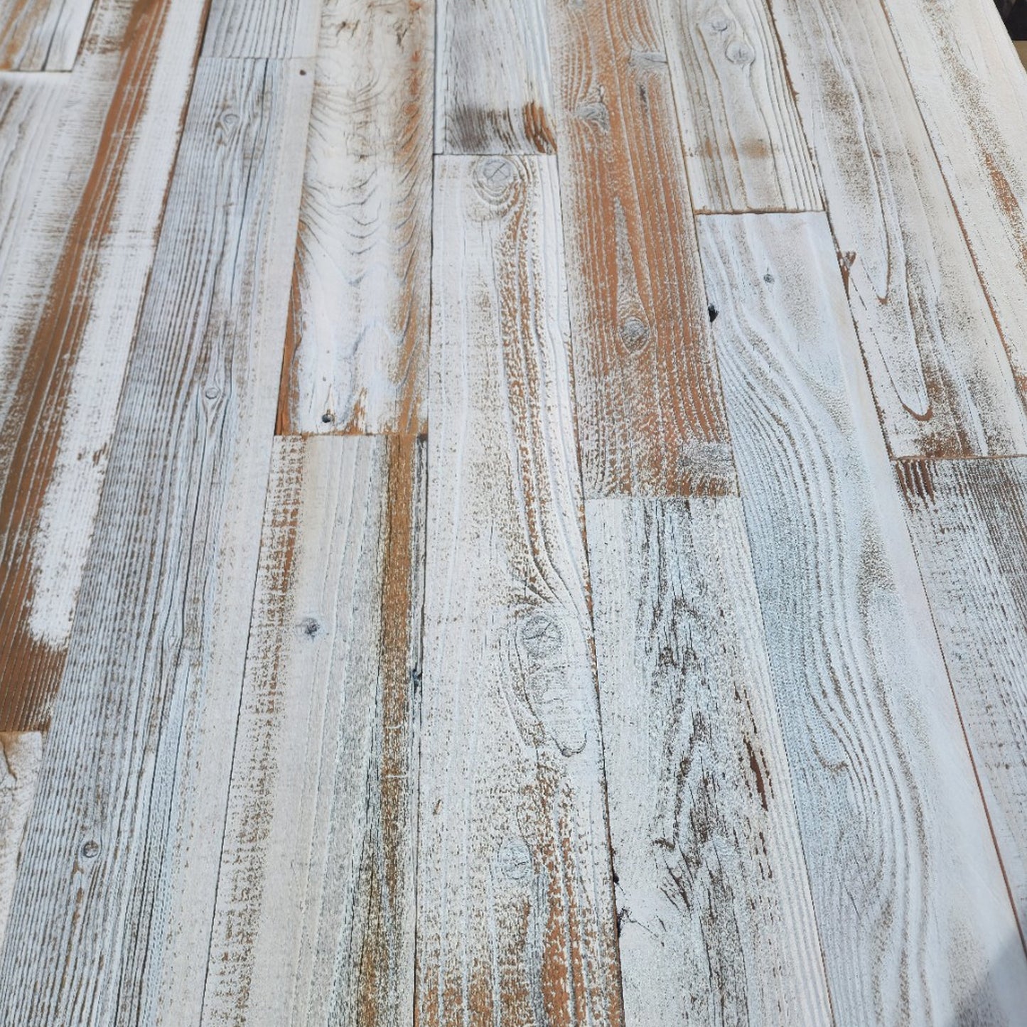 Whitewash finish reclaimed redwood showing board to board variation from near solid white to mostly bare wood