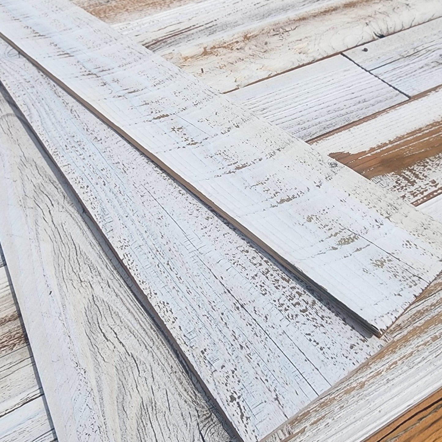 Close up of whitewash finish reclaimed redwood showing white sitting in the grain with warm wood beneath