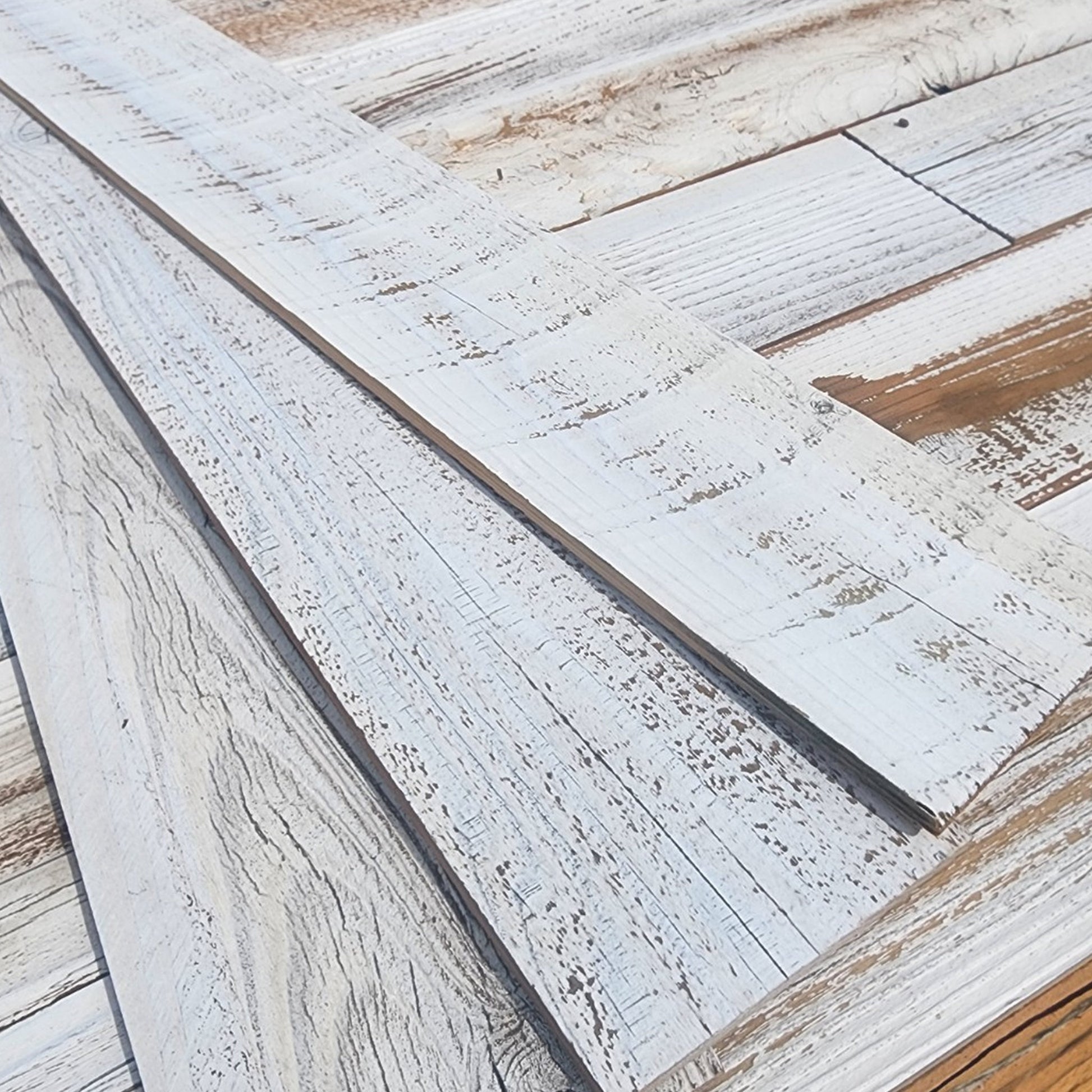 Close up of whitewash finish reclaimed redwood showing white sitting in the grain with warm wood beneath